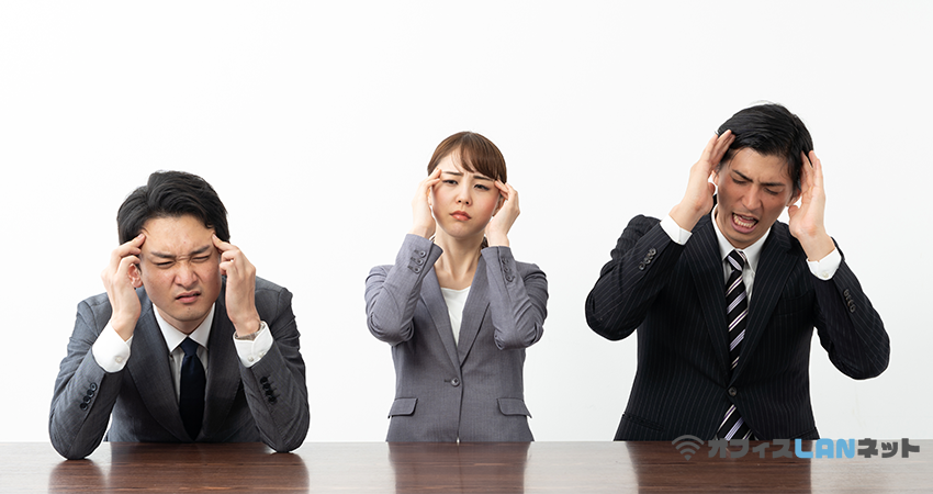 頭を抱える３人の社員